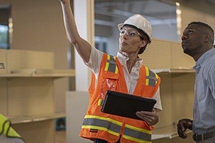 An IICRC Certified ServiceMaster project manager discusses mitigation with a commercial property manager.