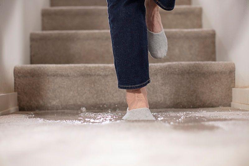 Homeowner steps into a flooded basement