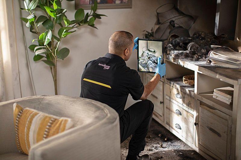 ServiceMaster By Simons fire technician takes photo's of damaged content in the household