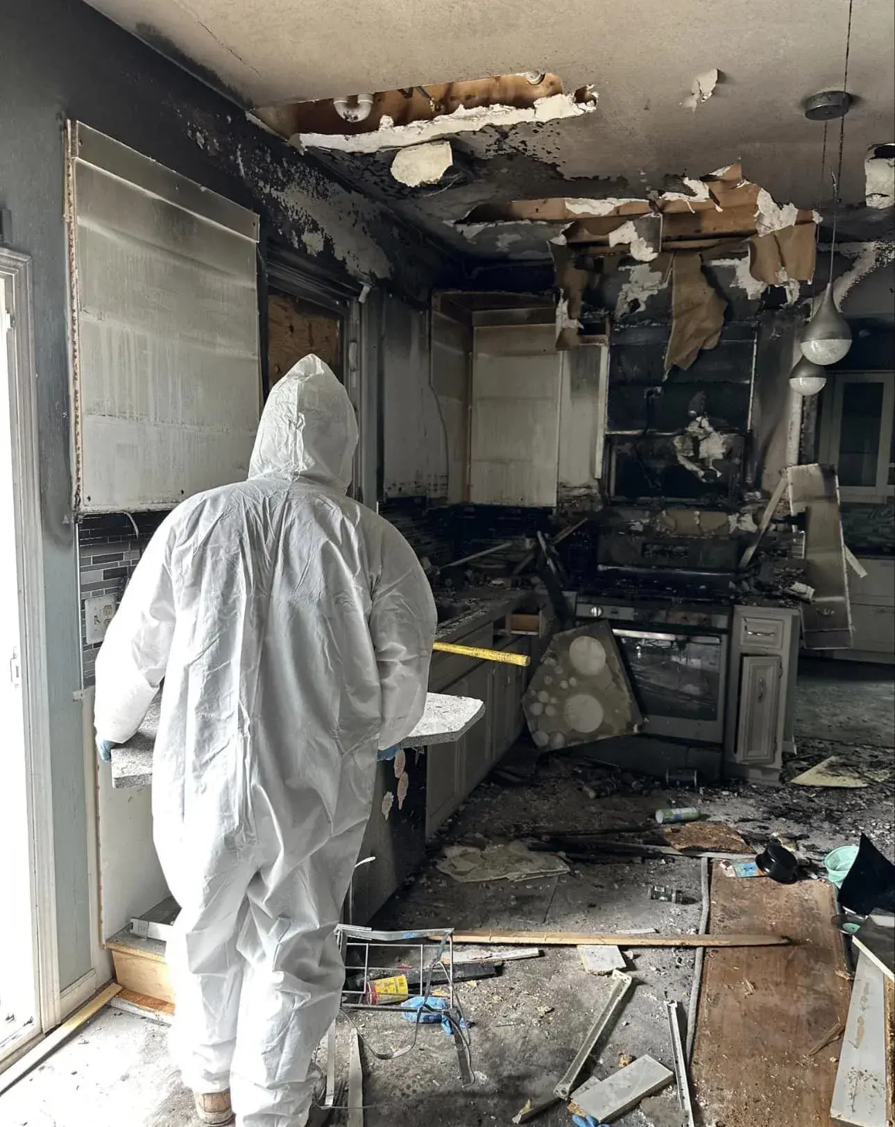 Technician in full PPE during a Fire Damage Cleanup
