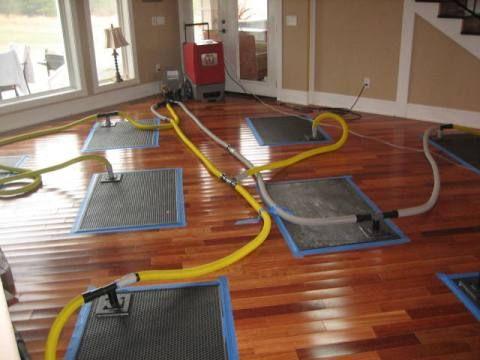 ServiceMaster Restoration By Simons wood floor drying mats in action.
