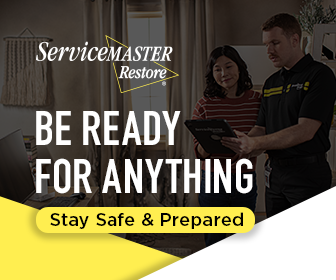 ServiceMaster Restoration By Simons technician discussing restoration with homeowner.