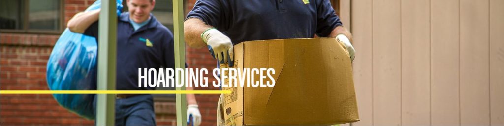 Hoarder And Clutter Cleaning - Albany Park - Chicago - IL - ServiceMaster Restoration By Simons - photo of two technicians removing items from a hoarders home